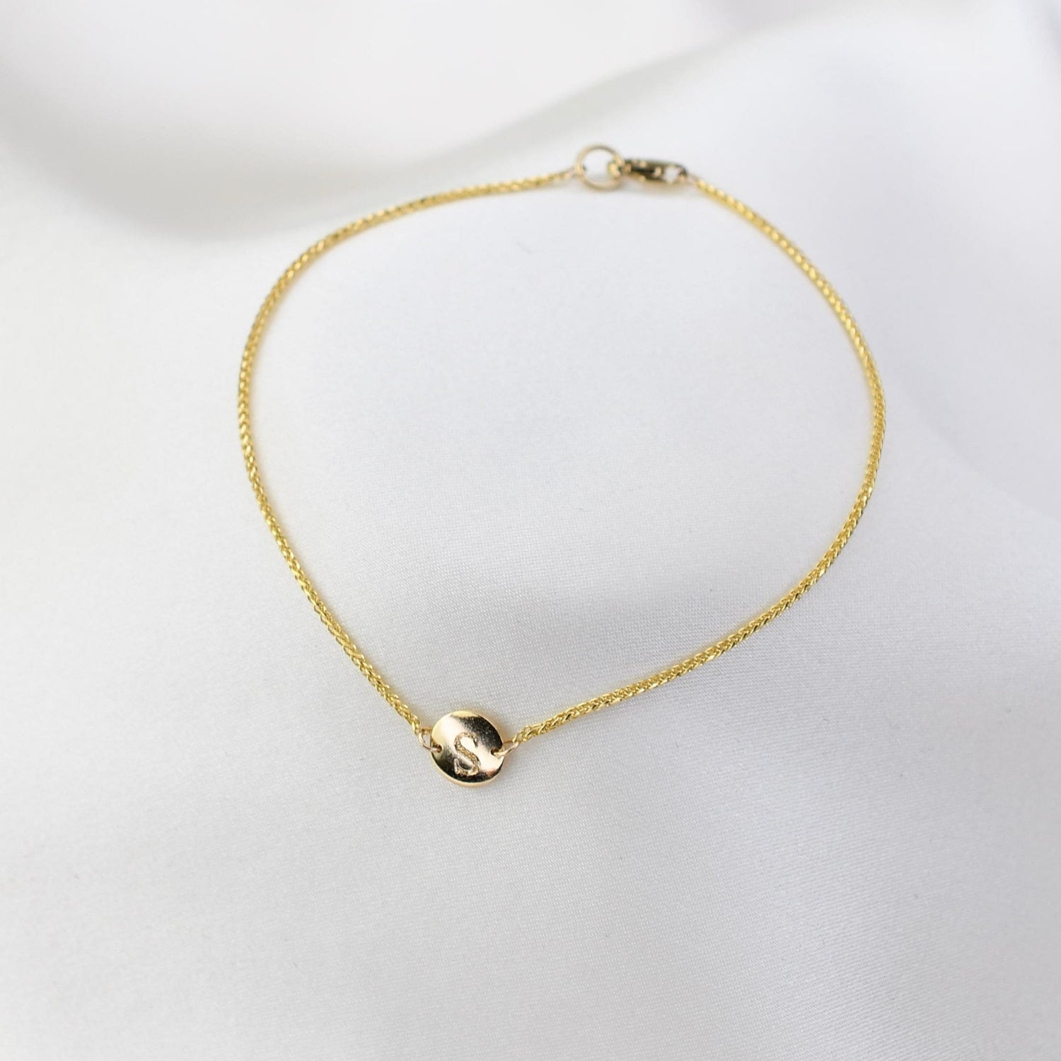 14K gold tiny initial bracelet with personalized letter charm, solid gold jewelry by Sash Jewelry, elegant and minimalist design