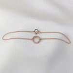 Rose gold bracelet on a light gray background