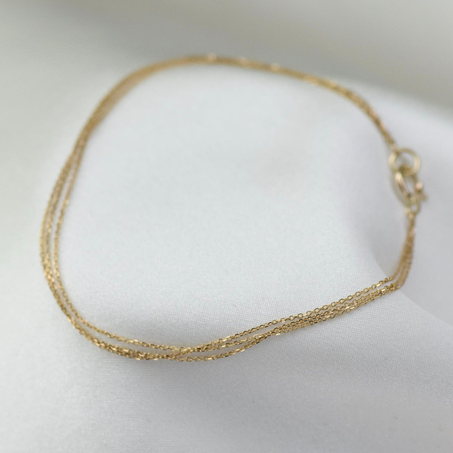 Gold bracelet on a white surface