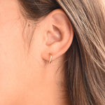 14K gold hoop earrings by Sash Jewelry, minimalist solid gold everyday earrings displayed on a white background.