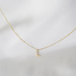 14K gold tiny diamond moon necklace on a delicate cable chain