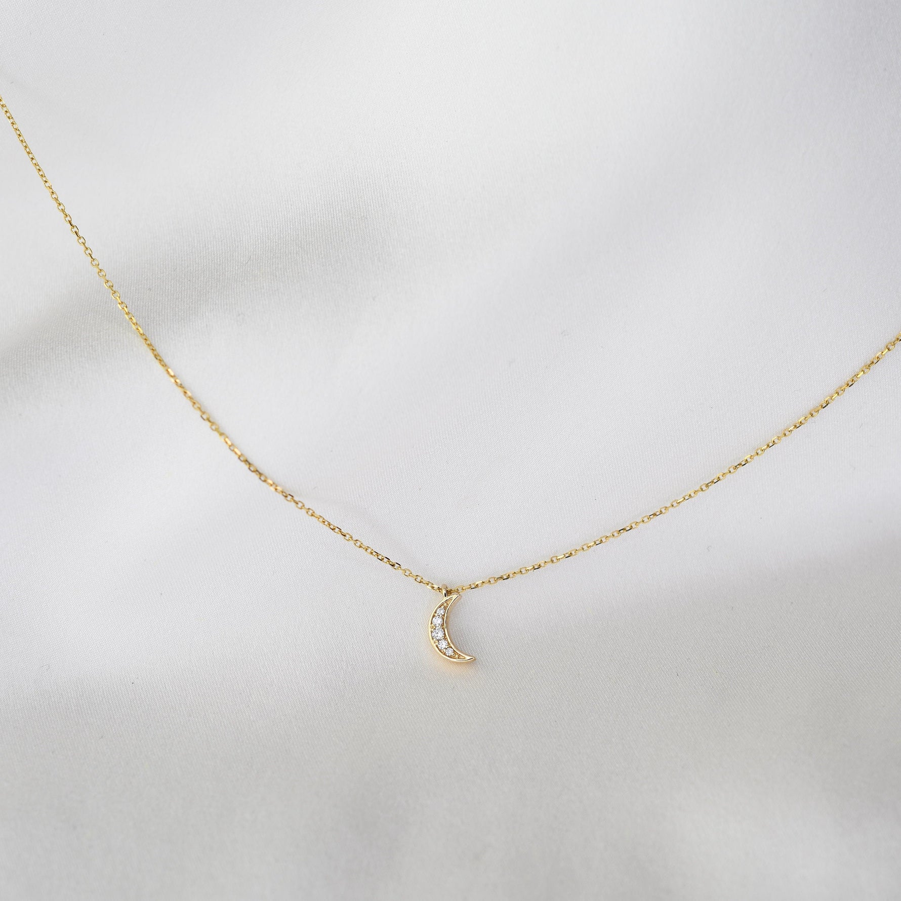 14K gold tiny diamond moon necklace on a delicate cable chain