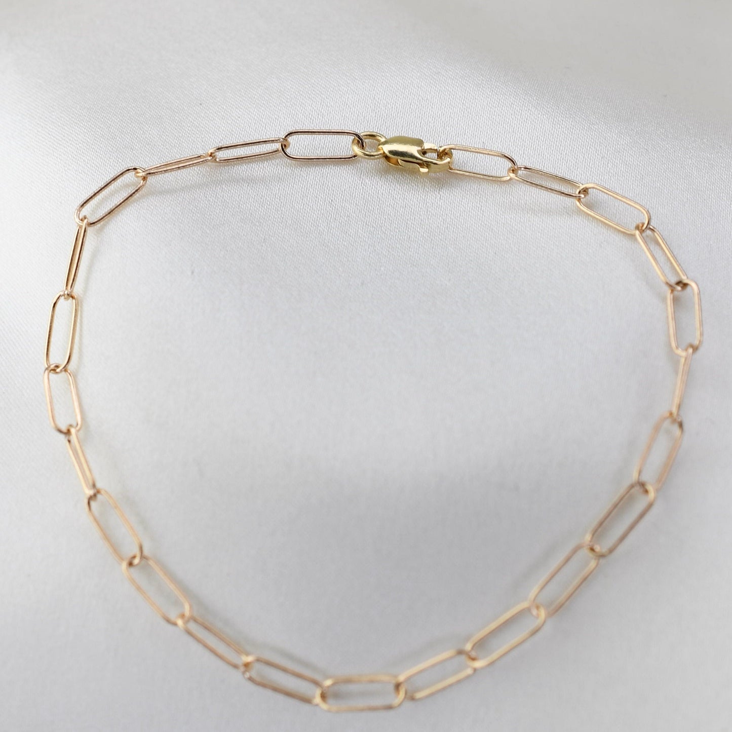 Minimalist 14K solid gold paper clip chain bracelet, 3mm wide. Perfect for everyday wear, stacking, or gifting. Durable, elegant, and timeless.