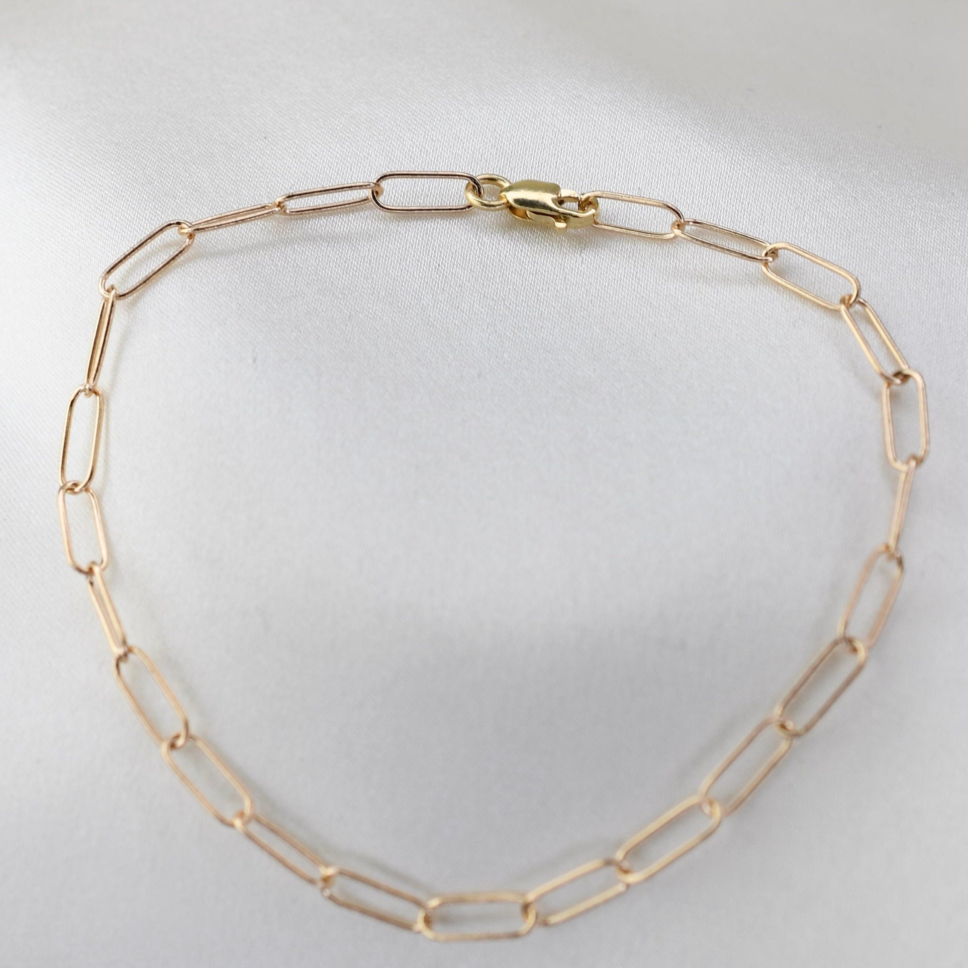 Minimalist 14K solid gold paper clip chain bracelet, 3mm wide. Perfect for everyday wear, stacking, or gifting. Durable, elegant, and timeless.