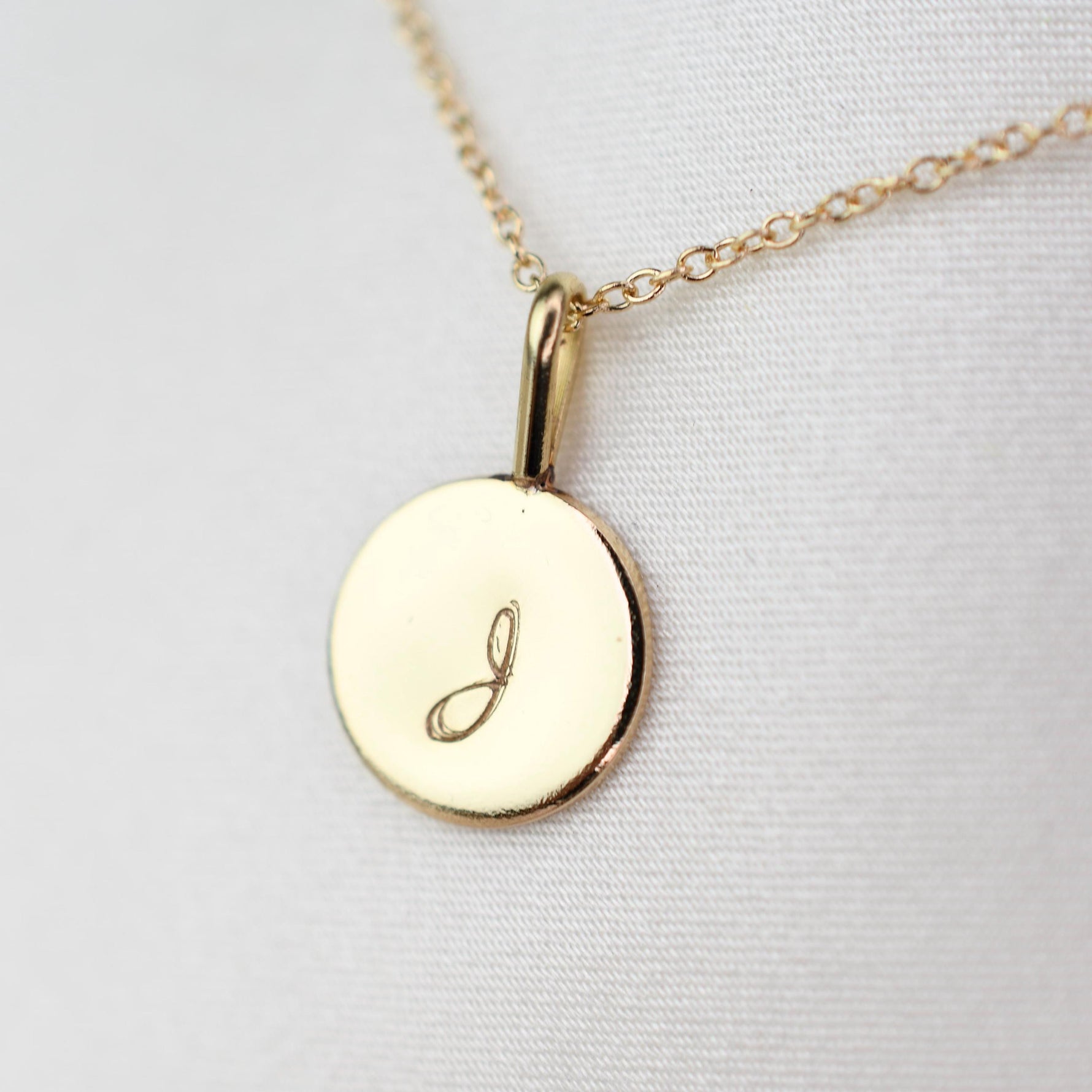 14K gold initial charm necklace featuring a minimalist gold disc pendant, designed by Sash Jewelry for elegant everyday wear.