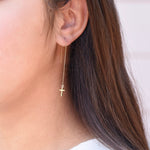 Minimal 14K gold faith earrings worn on ears
