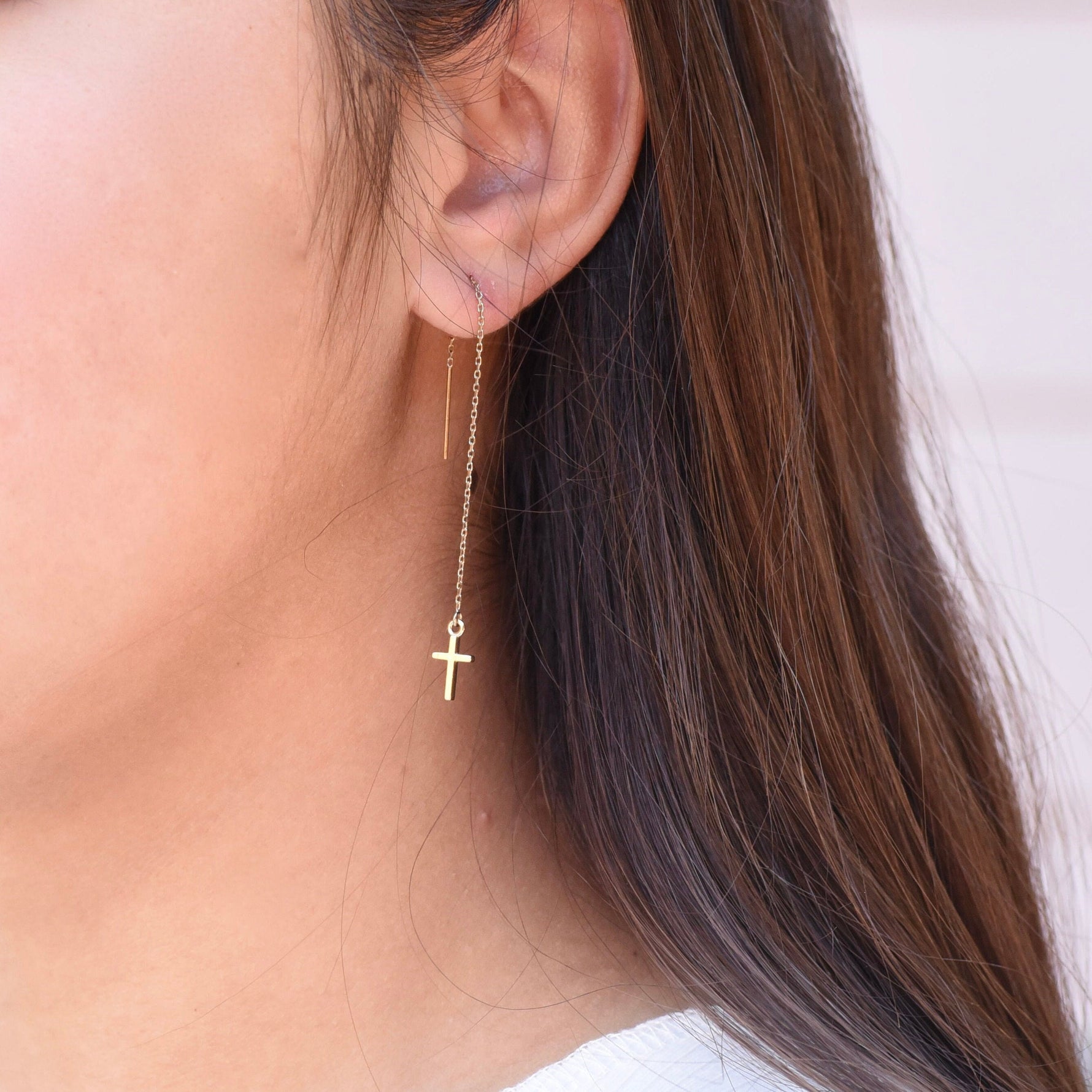 Minimal 14K gold faith earrings worn on ears