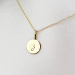14K gold initial charm necklace featuring a minimalist gold disc pendant, crafted by Sash Jewelry.