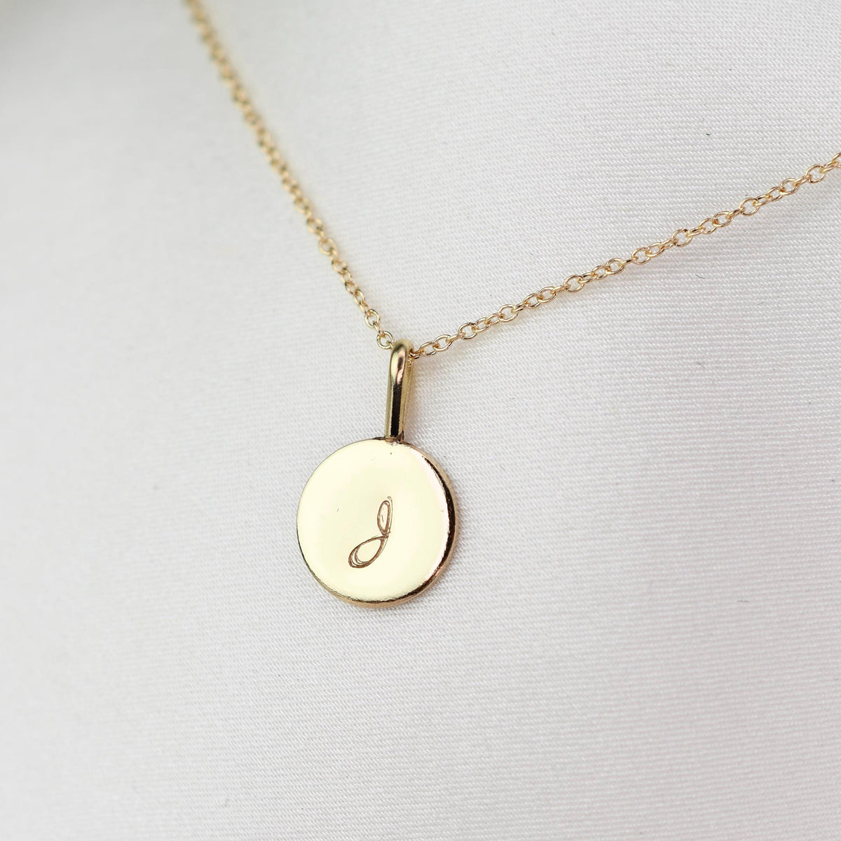 14K gold initial charm necklace featuring a minimalist gold disc pendant, crafted by Sash Jewelry.