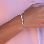 Gold bracelet on a wrist 