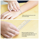 Instructions for measuring wrist size with a string and ruler on a yellow surface.