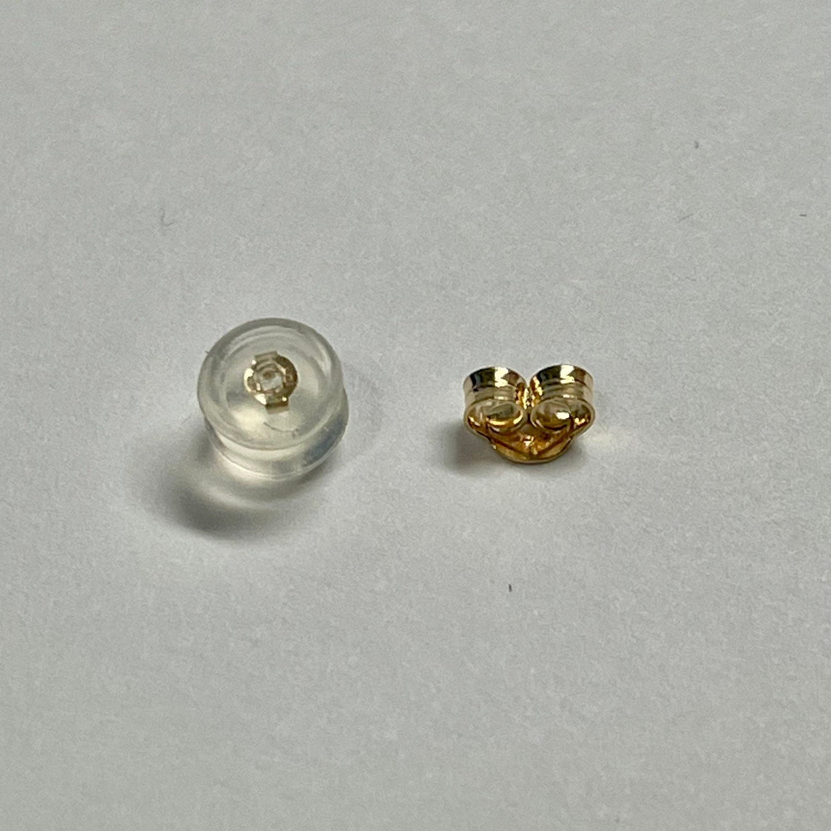 14K gold hoop earrings by Sash Jewelry, minimalist solid gold hoops for everyday wear, shown in close-up on a white background.