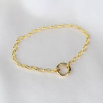 14K gold charm holder bracelet with rolo chain and hinged bail by Sash Jewelry, featuring a polished gold finish and clasp detail.