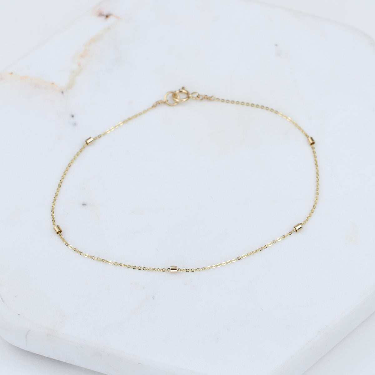 14K gold dainty bead chain bracelet by Sash Jewelry featuring a thin 1.5mm gold chain, close-up of the elegant jewelry piece.