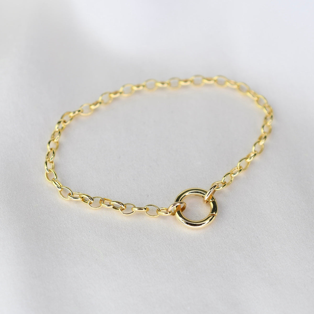 14K gold charm holder bracelet with rolo chain and hinged bail by Sash Jewelry, showcasing a sleek and elegant design