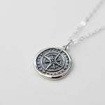 Sash Jewelry compass necklace with wax seal pendant, featuring intricate travel-themed design, on a chain for stylish wear.