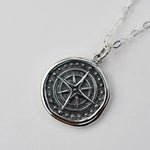 Sash Jewelry compass necklace with wax seal pendant, ideal for travelers, featuring a detailed metal compass design on a chain.