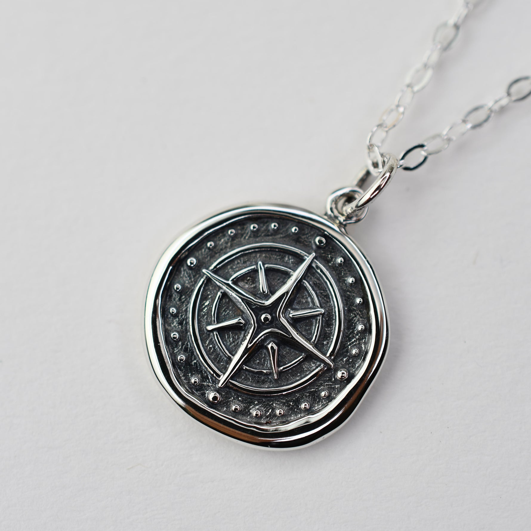 Sash Jewelry compass necklace with wax seal pendant, ideal for travelers, featuring a detailed metal compass design on a chain.