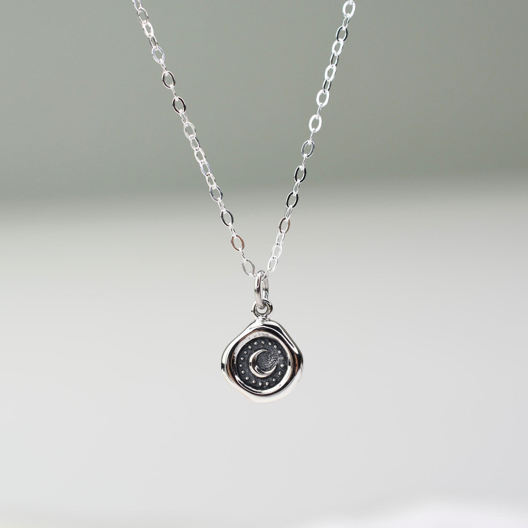 Sterling silver crescent moon wax seal necklace with 17mm x 10mm charm on silver chain