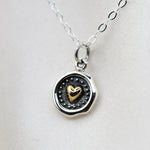 Sterling silver and bronze small heart necklace with wax seal heart charm, featuring a delicate chain and detailed pendant.
