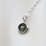 Sterling silver and bronze small heart necklace with wax seal heart charm by Sash Jewelry, featuring detailed metalwork and delicate chain.