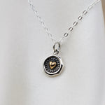 Sterling silver and bronze small heart necklace with wax seal heart charm, featuring delicate chain and detailed design.
