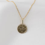 Gold necklace with a 14k compass pendant
