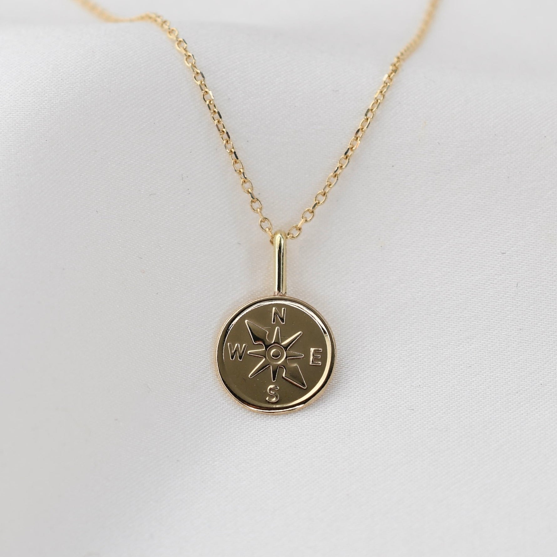 Gold necklace with a 14k compass pendant