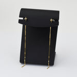 Black pouch with gold drawstring on a white background