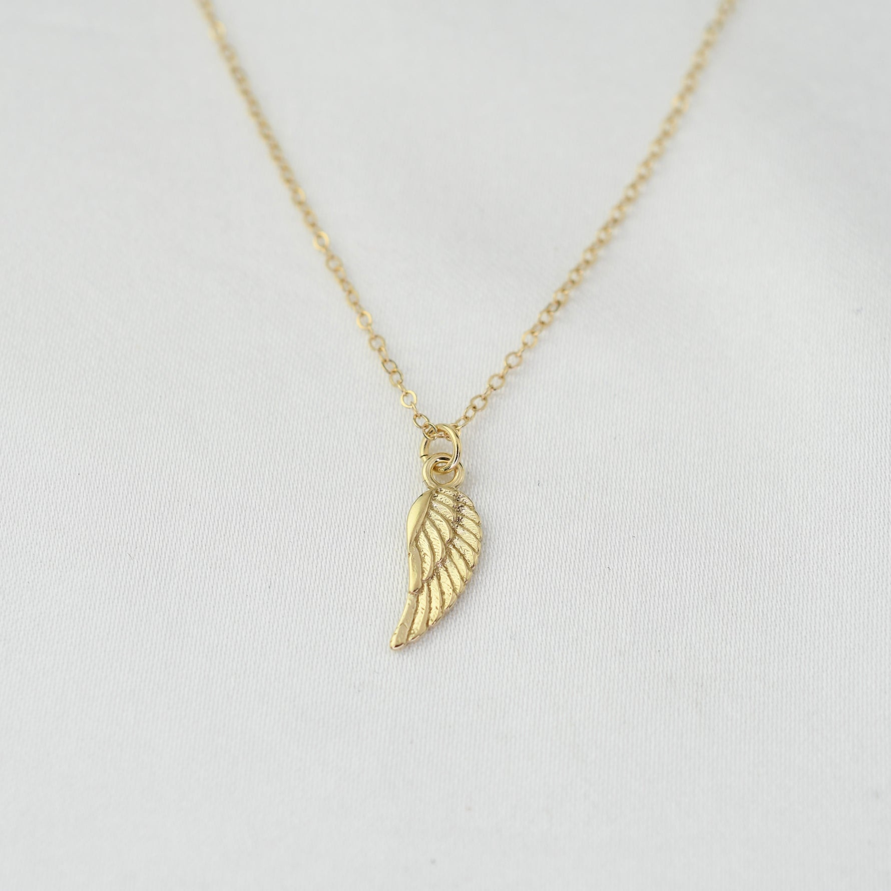 14K solid gold angel wing necklace by Sash Jewelry, featuring detailed feather design and elegant chain.