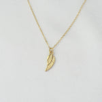 14K solid gold angel wing necklace by Sash Jewelry, featuring detailed wing pendant on a delicate chain.