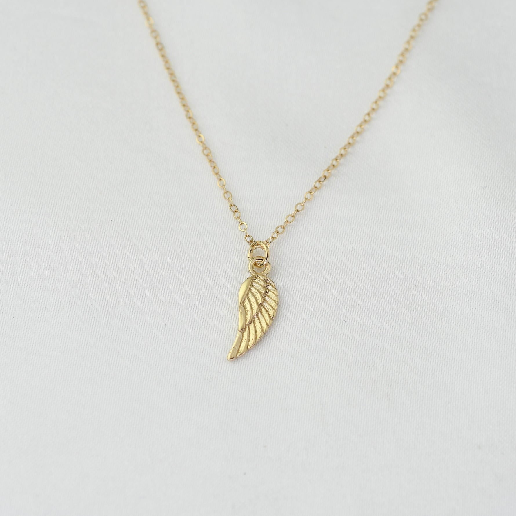14K solid gold angel wing necklace by Sash Jewelry, featuring detailed wing pendant on a delicate chain.