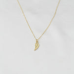14K solid gold angel wing necklace by Sash Jewelry, featuring detailed wing pendant on a delicate chain.