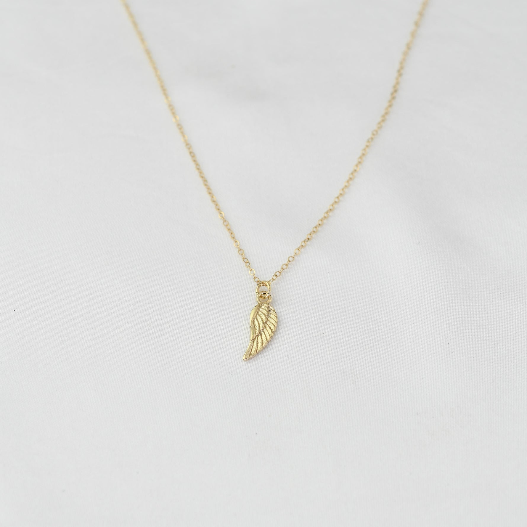 14K solid gold angel wing necklace by Sash Jewelry, featuring detailed wing pendant on a delicate chain.