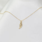 14K solid gold angel wing necklace by Sash Jewelry, featuring detailed angel wing pendant on a fine chain.