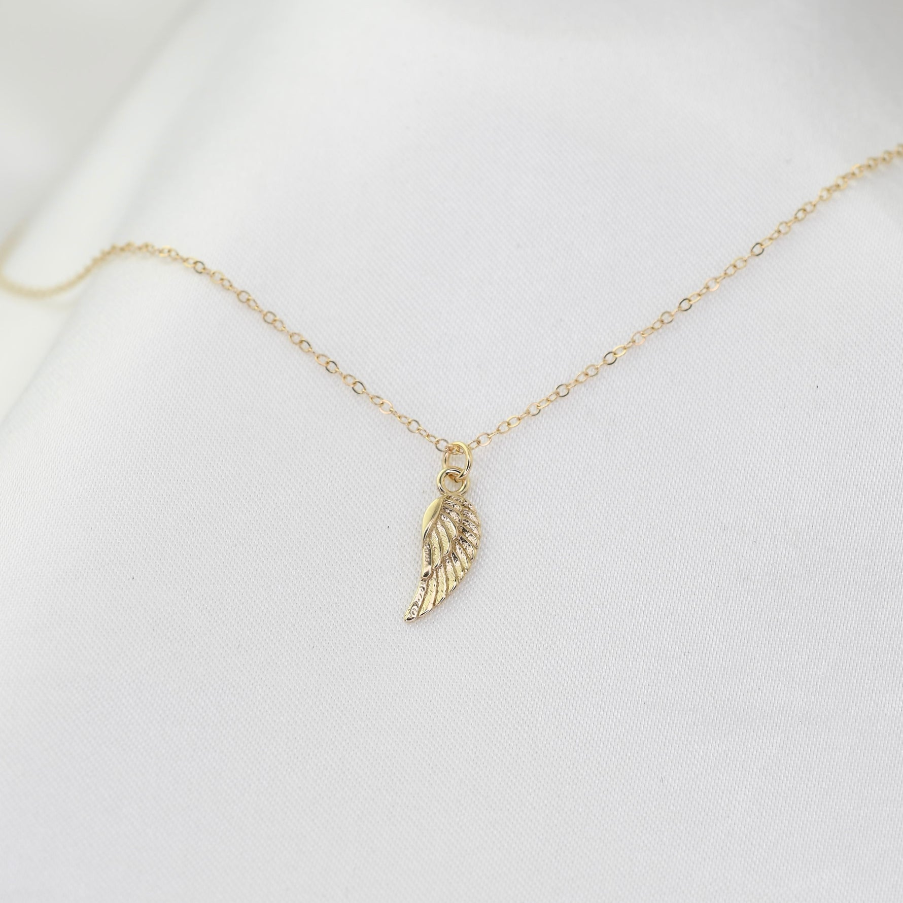 14K solid gold angel wing necklace by Sash Jewelry, featuring detailed angel wing pendant on a fine chain.