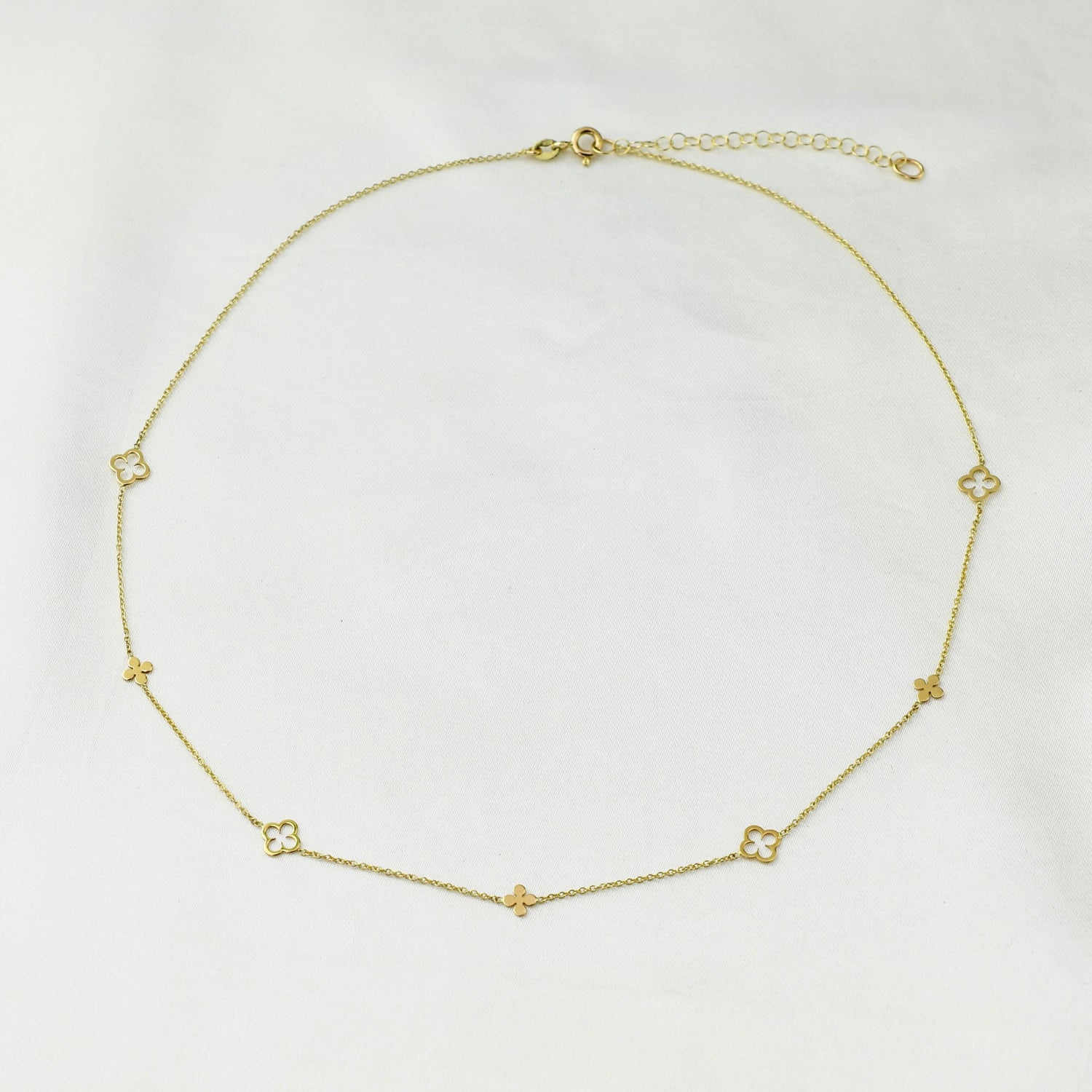 14K gold clover necklace by Sash Jewelry featuring a delicate four-leaf clover pendant on a fine chain.