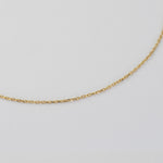 A delicate gold chain necklace photographed on a plain white background.