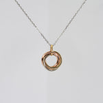 14K solid gold tri-color necklace with three interlocking yellow, white, and rose gold rings on a delicate adjustable chain.