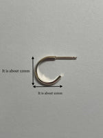 14K gold hoop earrings by Sash Jewelry, minimalist solid gold hoops perfect for everyday wear, shown in a close-up image.