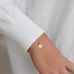 14K gold personalized heart charm bracelet with paper clip chain, featuring yellow and white gold options from Sash Jewelry.