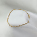 Gold bracelet on a white surface