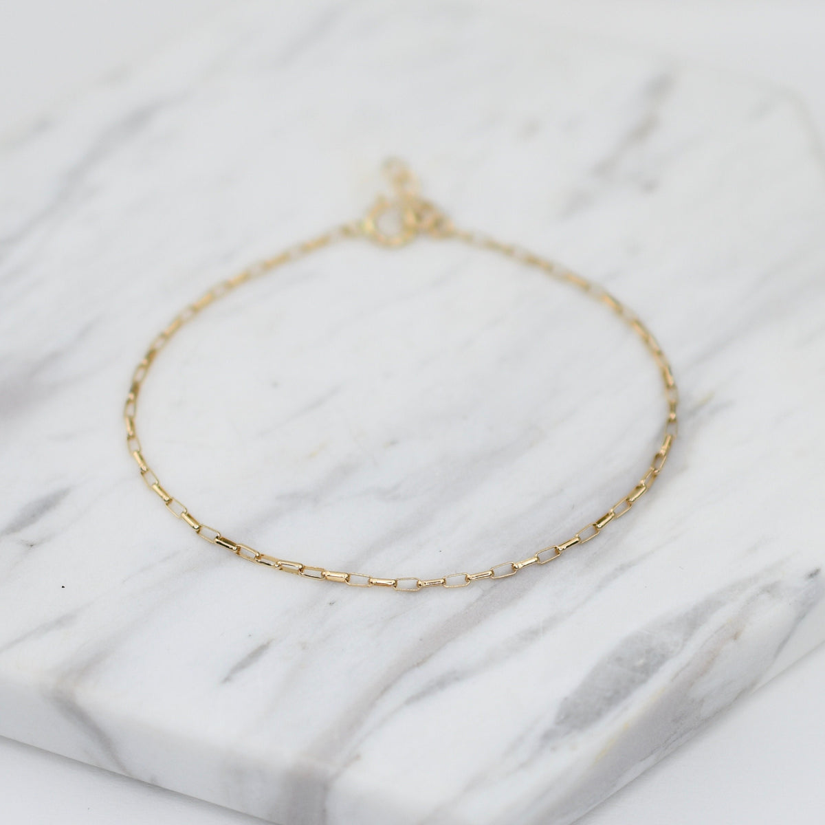 14K gold delicate anklet by Sash Jewelry featuring a dainty solid gold chain with extension for adjustable fit.