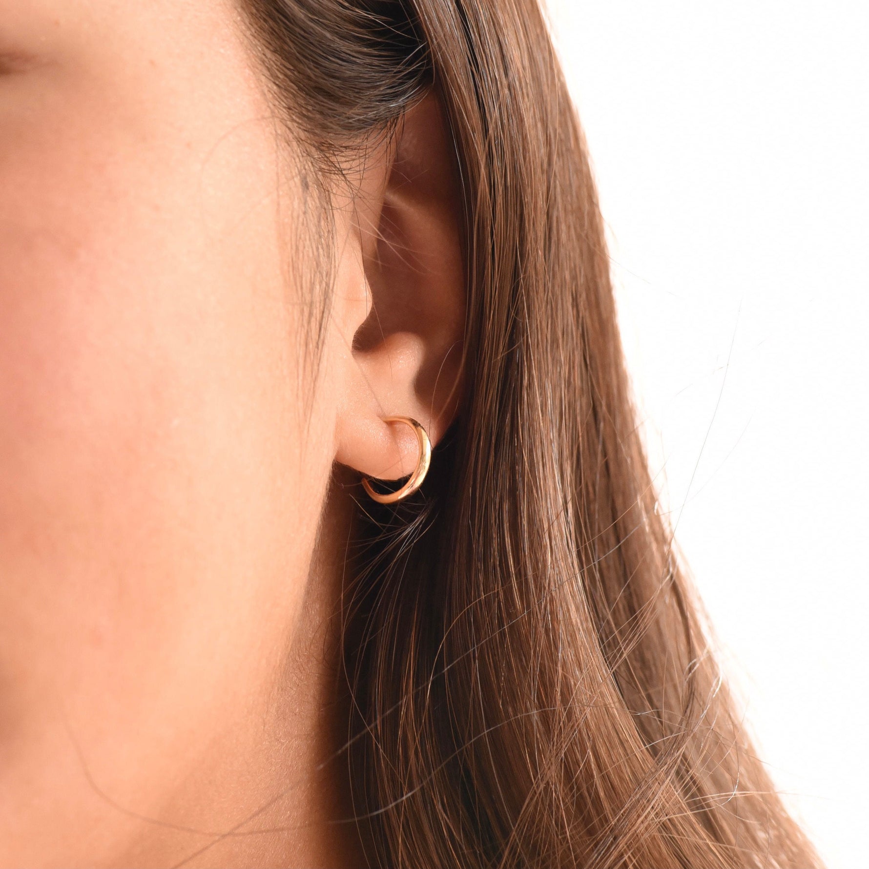14K gold hoop earrings by Sash Jewelry, minimalist solid gold everyday earrings with a sleek, classic design.