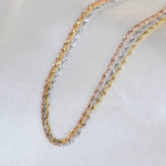 14K gold dainty tri-color Singapore chain bracelet with sparkling accents, crafted by Sash Jewelry.