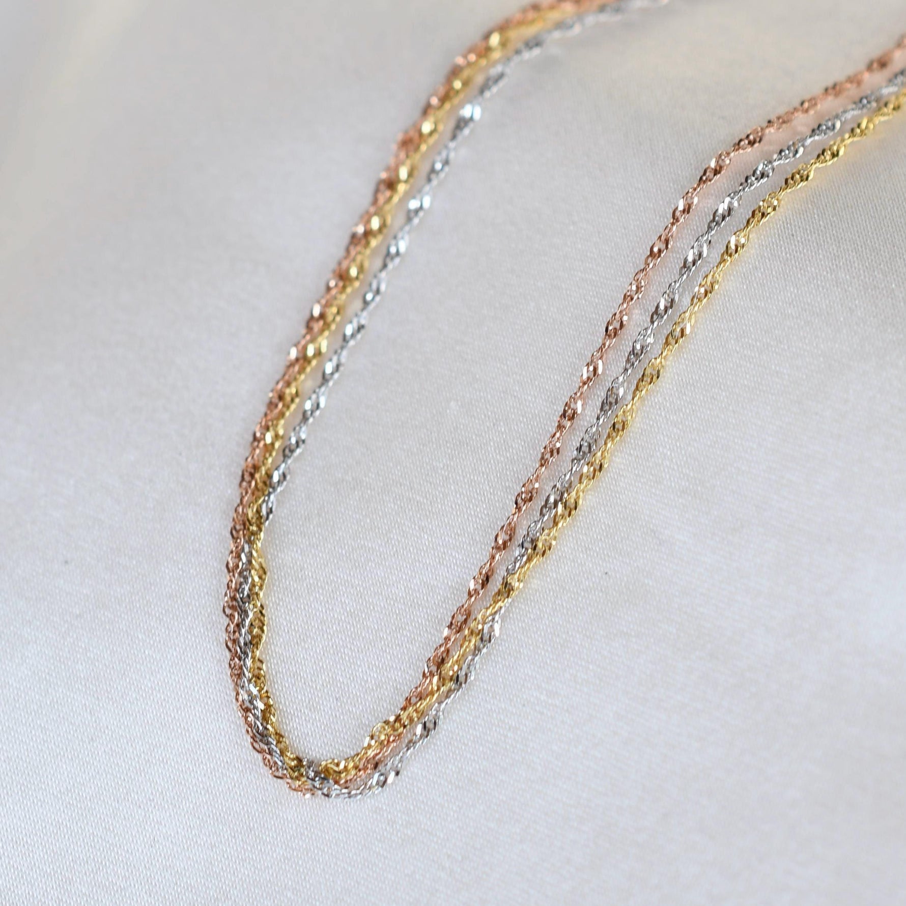 14K gold dainty tri-color Singapore chain bracelet with sparkling accents, crafted by Sash Jewelry.
