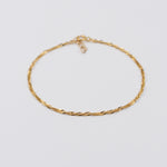 Gold chain necklace on a light gray background