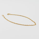 Gold chain on a light gray background