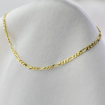 Gold chain necklace on a mannequin bust with a white background