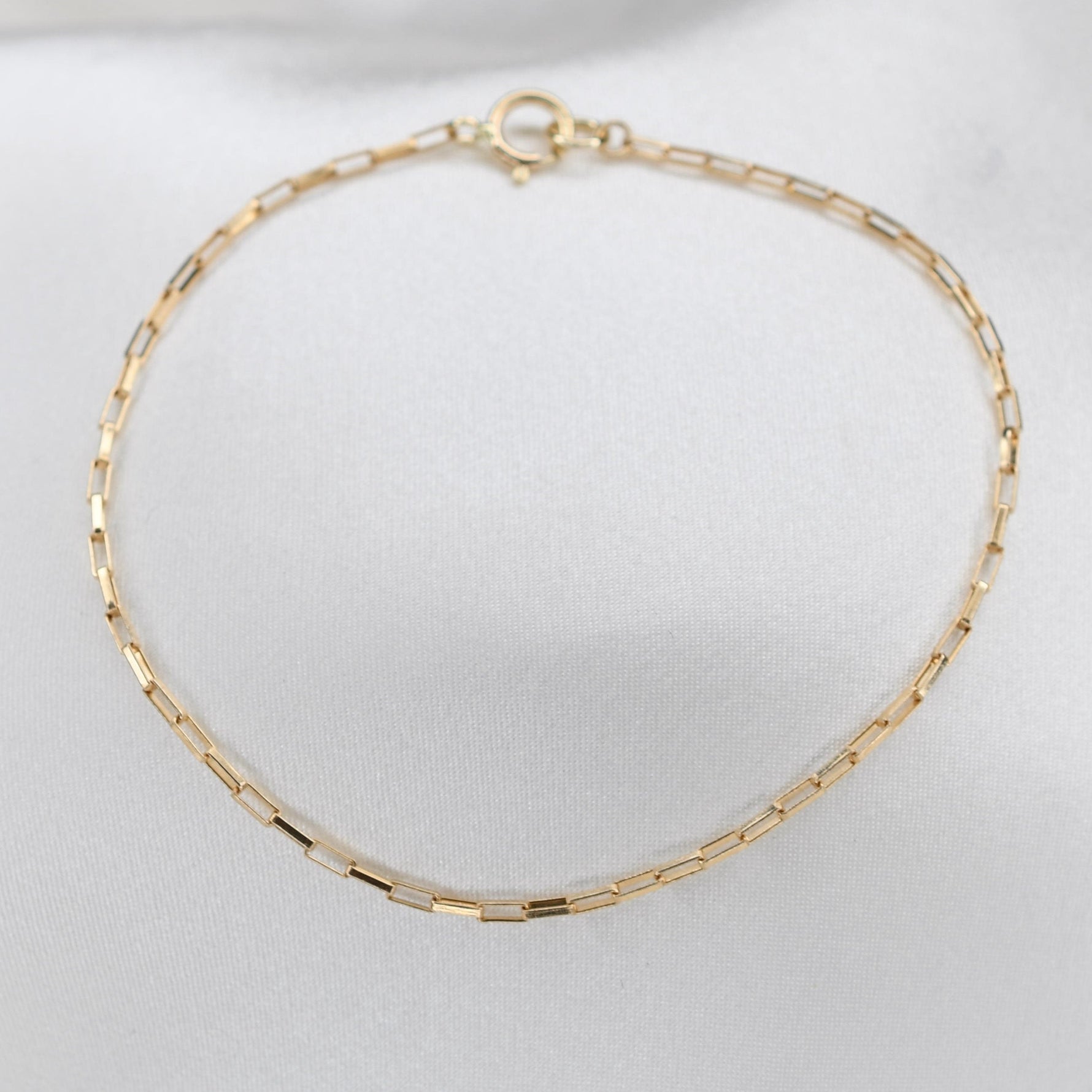 Elegant 14K yellow gold anklet with a 1.2mm rectangle box chain. Crafted from solid gold for lasting shine, this delicate anklet is perfect for daily wear or gifting. Available in 8.5"–10.5" lengths. Timeless, versatile, and effortlessly chic.
